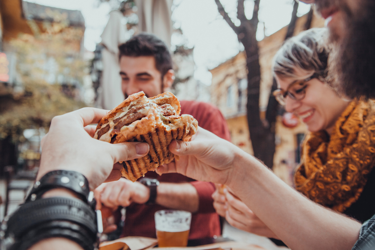 a photo of a group of restaurant customers enjoying a nice meal