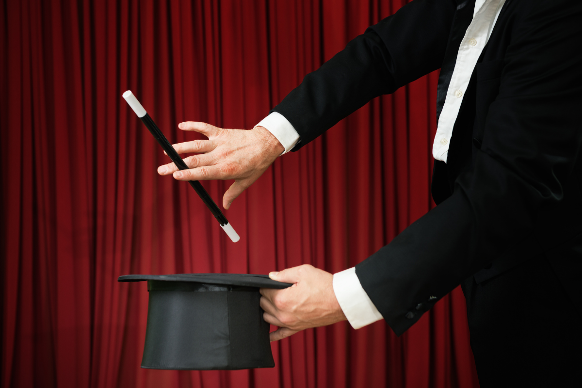 a photo of a magician preparing to pull something out of a hat
