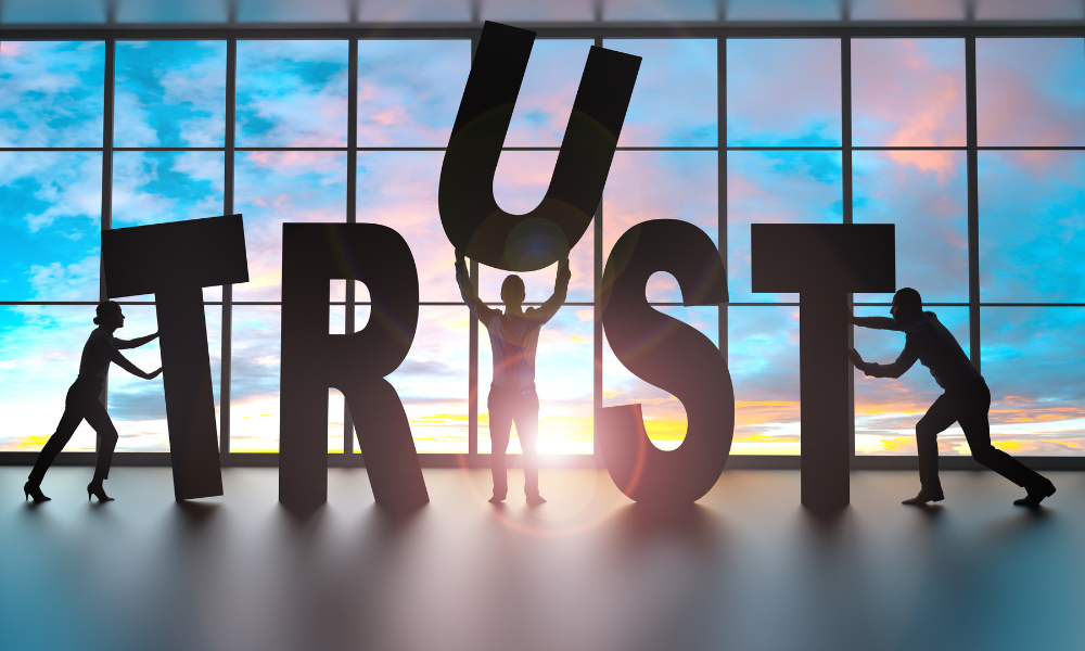 Employees spelling the word TRUST in large letters.