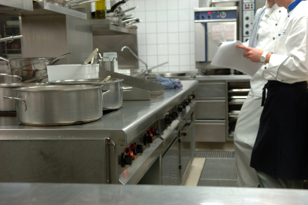 Two chefs sorting out the organization of a kitchen.