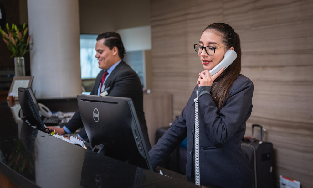 The 5 Biggest Hr Trends Influencing The Hotel Industry Now 6 Hotel industry employees working the reception desk and answering phones.