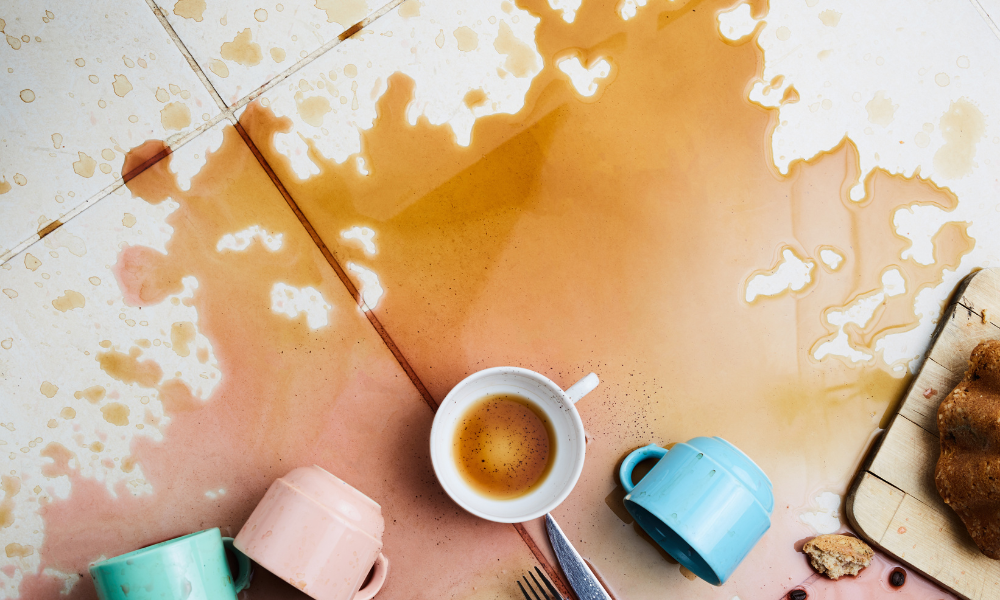 Breakfast tray dumped on the floor, with coffee spilled everywhere.