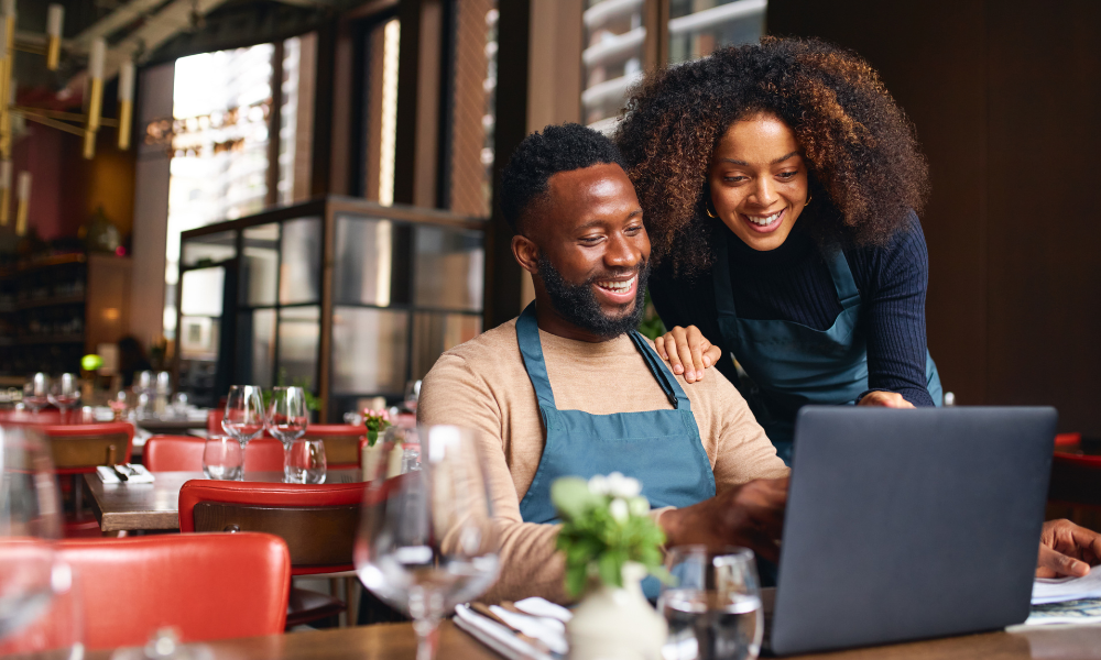 African American couple managing restaurant.