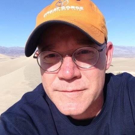 Man in glasses and a yellow hat.