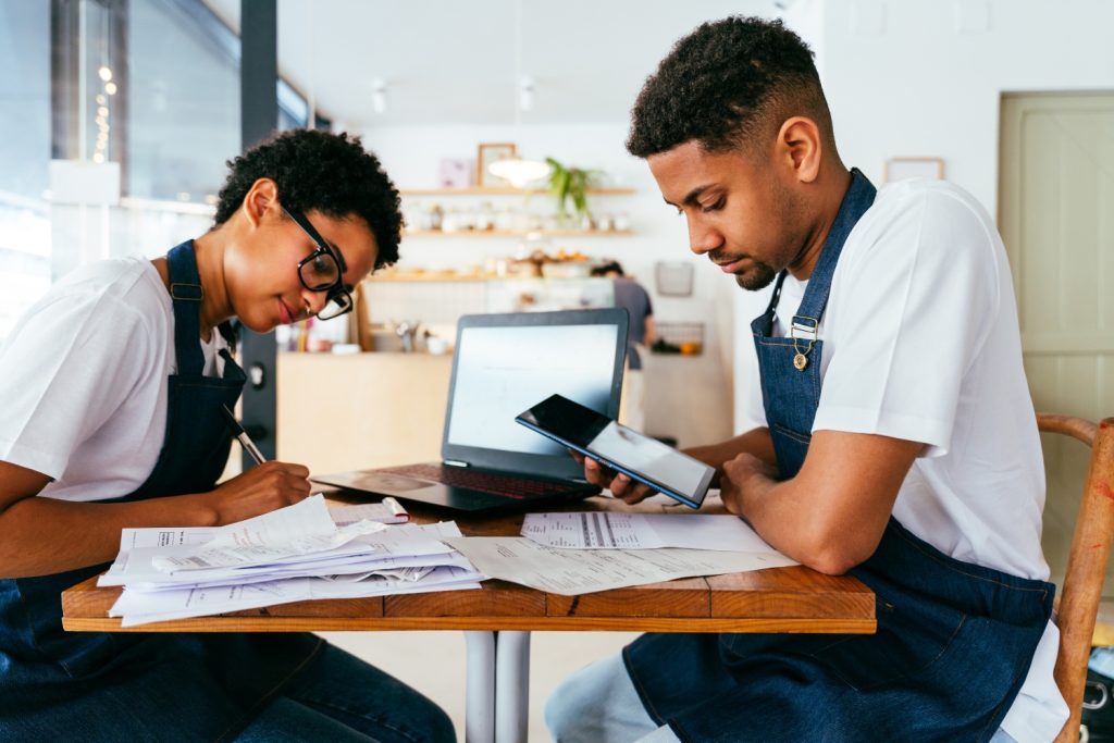 Restaurant operators reviewing restaurant food and labor costs on a laptop