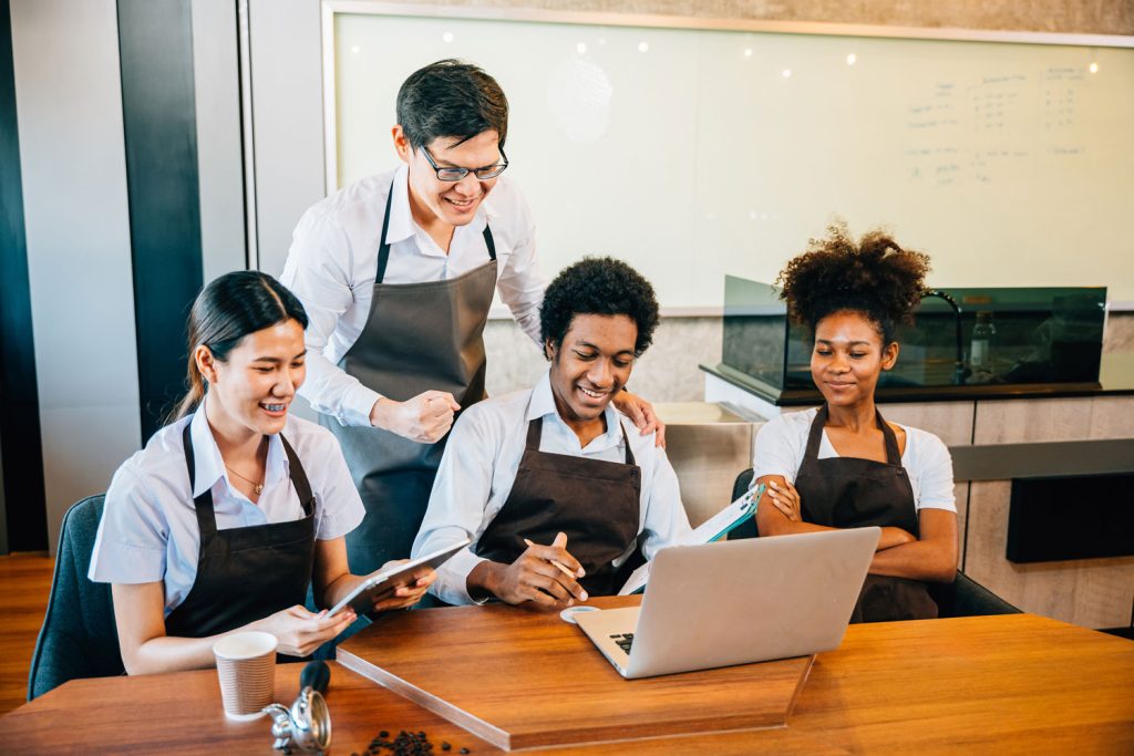 How To Handle Last-Minute Employee Callouts (Before They Become A Labor Cost Problem) 1 Restaurant manager and staff reviewing scheduling system to prevent last-minute employee callouts