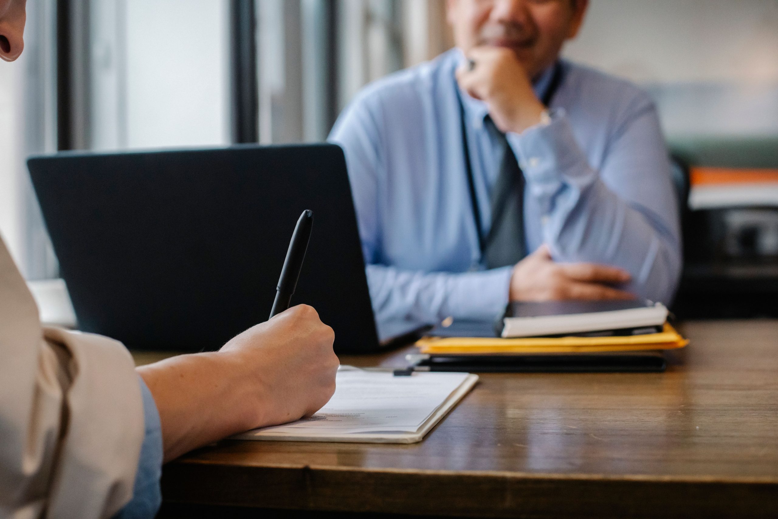 Manager reviewing new hire paperwork with an employee during onboarding