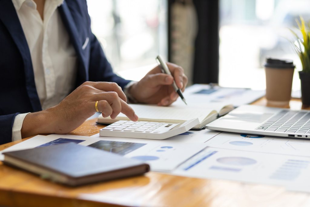 Work Opportunity Tax Credit: The Federal Tax Benefit High-Turnover Operators Are Missing 1 Restaurant operator calculating Work Opportunity Tax Credit savings on a calculator
